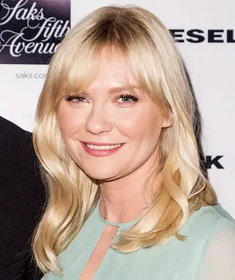 Kirsten Dunst medium-length loose waves with bangs