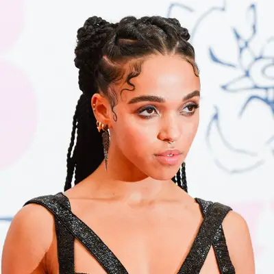 Singer FKA Twigs with a space bun cornrow hairstyle