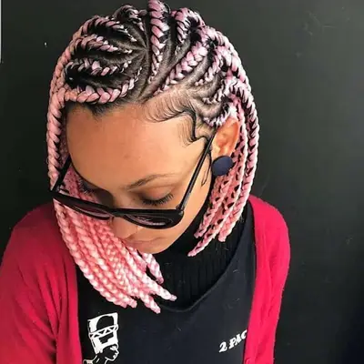 Close up of a cornrow bob hairstyle with pink extensions and an asymmetrical design