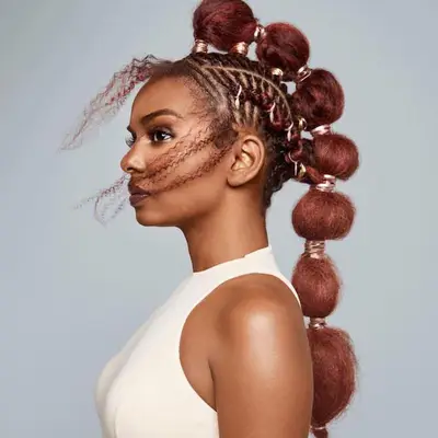 Close up of a cornrow hairstyle with afro puffs down the center of the head