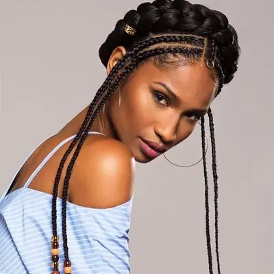 A model with a milkmaid braid with two cornrowed braids toward the front of the head