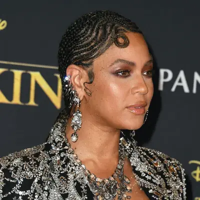 Beyoncé with cornrows styled into a swoopy curl on her forehead
