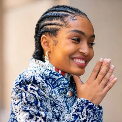 Yara Shahidi viewed from the side, her hair in cornrows of varying size