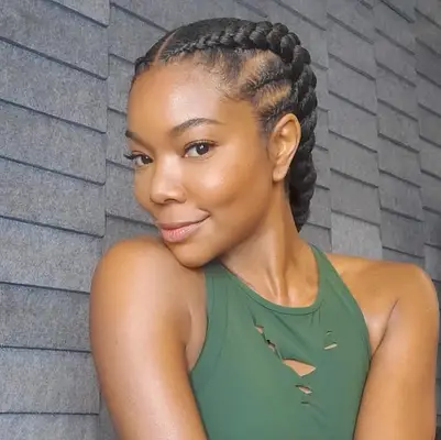 Gabrielle Union with two large cornrows, two smaller cornrows fed into them on the side