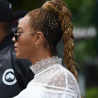 Beyonce viewed in side profile, her cornrowed hair in a braided blonde ponytail