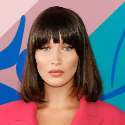 bella hadid poses with blunt brown bangs and bob