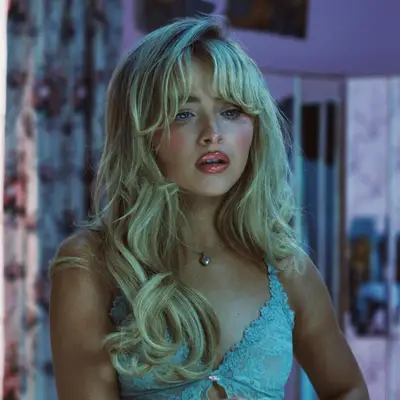 Penelope Cruz with coarse wispy bangs in front of porsche sing