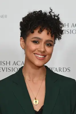 Nathalie Emmanuel natural curly wispy bangs in emerald green blazer