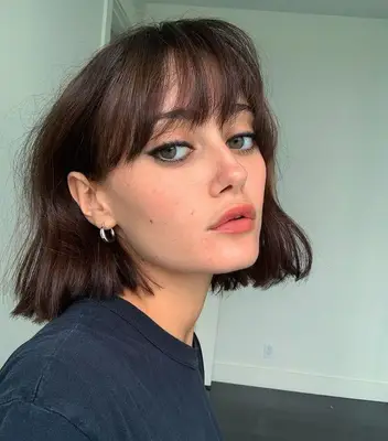Ella Purnell textured bob with wispy bangs and heavy eyeliner