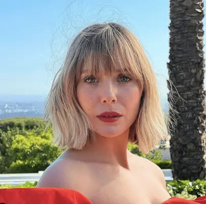 elizabeth olsen in red off the shoulder dress with bobs and long wispy straight bangs