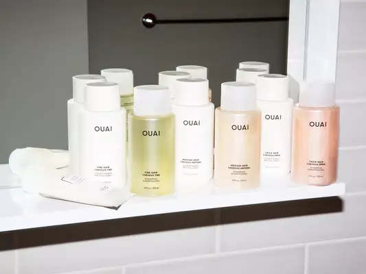 A variety of Ouai hair care products on a shelf