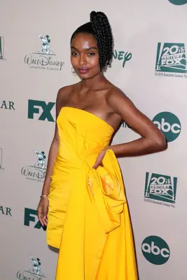 Yara Shahidi with a short, braided, side ponytail