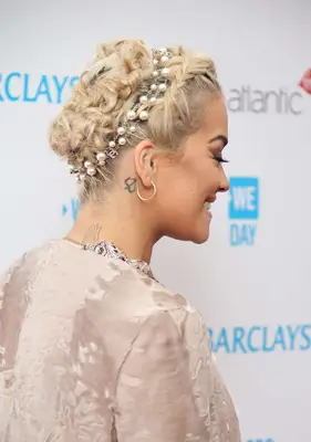 Rita Ora wearing a short braided updo