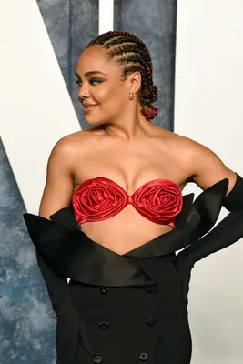 Tessa Thompson wearing red corn rows