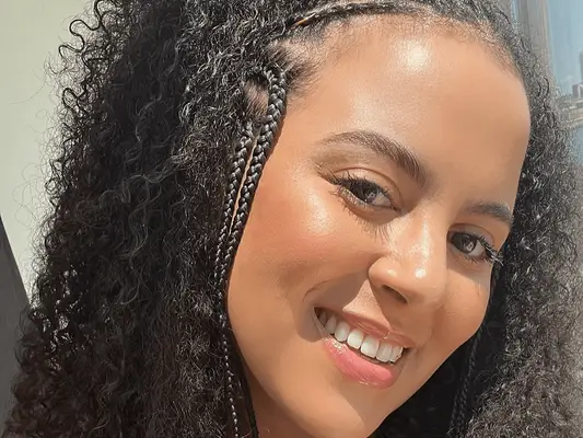 woman with face-framing braids on short hair