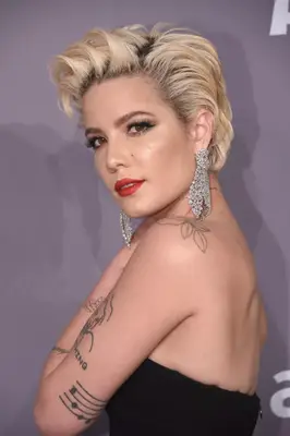 Halsey with a volumized blonde pixie with dark roots