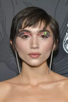 Rowan Blancard in a pixie with bangs and rainbow glitter eye makeup