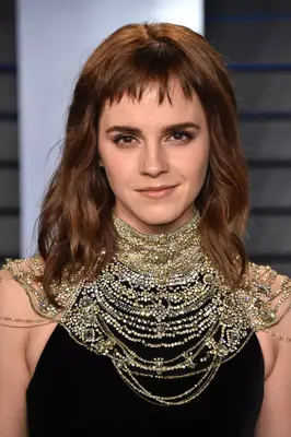 Emma Watson with micro bangs and wavy shoulder-length hair