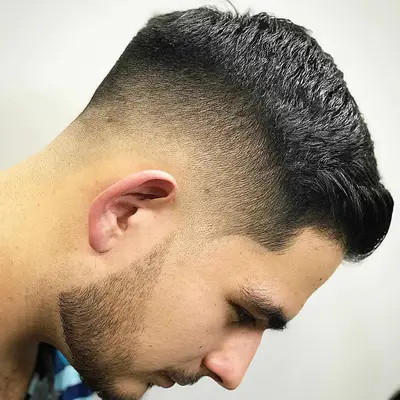 Side view of man with high-low skin face haircut and defined facial hair