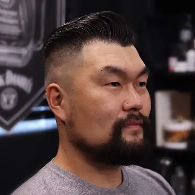 Man with gelled hair with bald skin fade sides