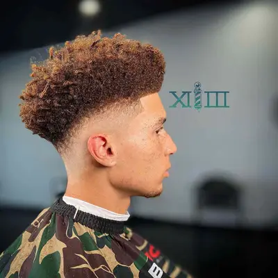 curly haircut with bald fade on sides 
