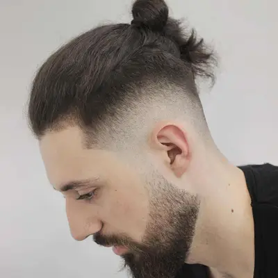 Side view of faded undercut with man bun on top