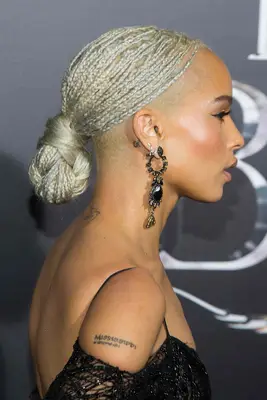 Zoe Kravitz wearing blonde braids in a low bun