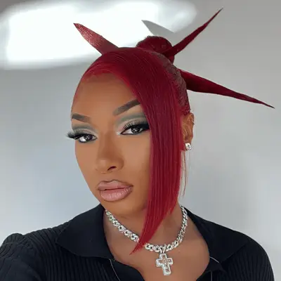 Janelle Monae with a high natural curly bun