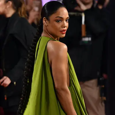 Tessa Thompson wears a long braided low ponytail