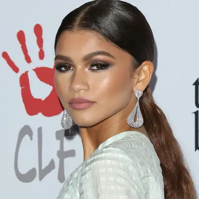 Zendaya wears a sleek, wavy low ponytail
