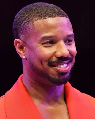 Michael B. Jordan with clean buzz cut and mustache