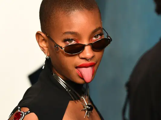willow smith with a buzz cut sticking out tongue
