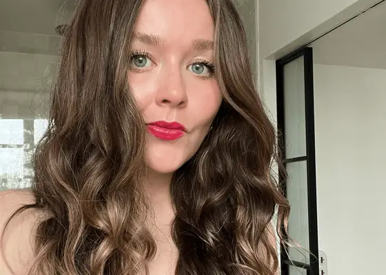 close up of woman in red lipstick with wavy hair