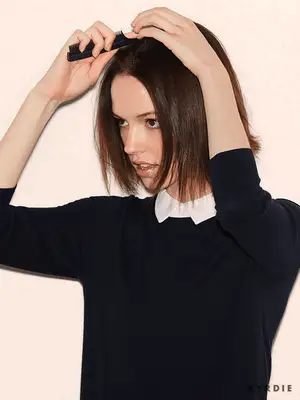 Close up of a model parting her short brown bob.