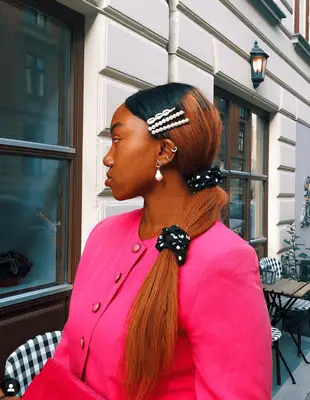 pink and black oversized ruffle scrunchie over a low sock bun