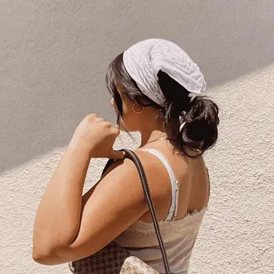 woman with messy ponytail in a bandana