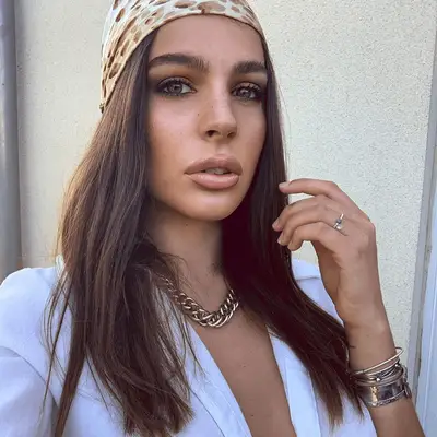 woman with straight hair swept back in bandana