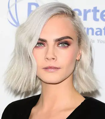 Cara Delavigne with a deep side part