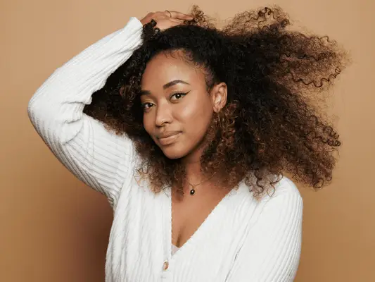 Close up of a model with curly hair. 