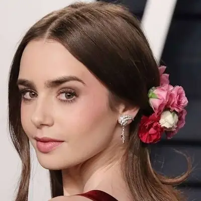 Lily Collins with floral accessory in hair