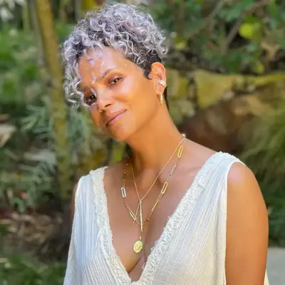 halle berry hair styled in asymmetrical cut with silver gray curls