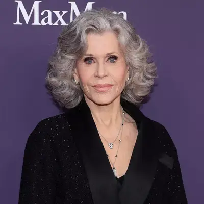 Jane Fonda in voluminous loose gray waves on red carpet