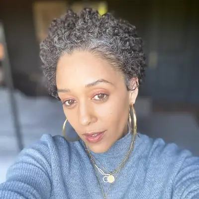 Tia Mowry in gray short naturally curly haircut