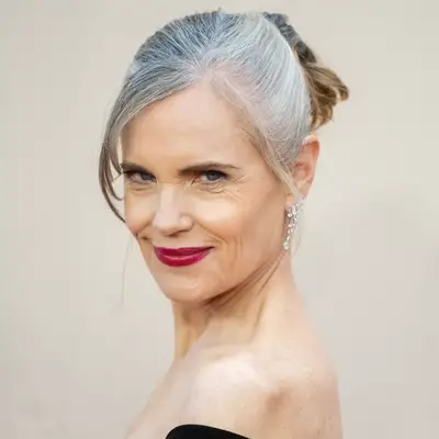 Elizabeth McGovern in a short gray ponytail updo 