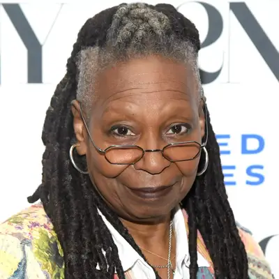 Whoopi Goldberg in naturally gray locs on red carpet