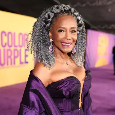 Margaret Avery in salt and pepper gray curly crochet hair with goddess crown braid
