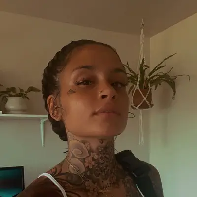 Kehlani wearing a low braided bun