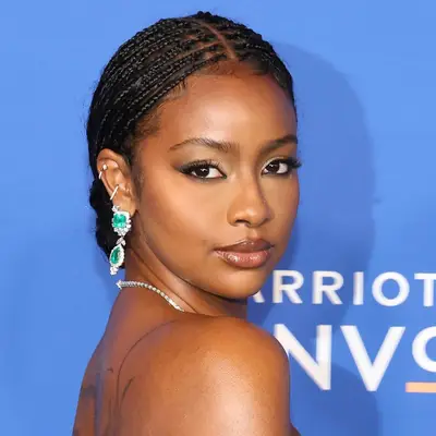 Justine Skye wearing middle-parted micro box braids into a low bun at the 2024 Billboard Women In Music Awards in Inglewood, California 