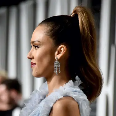 Jessica Alba wears a mid-length tousled high ponytail with extra lift at the base