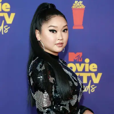 Lana Condor wears a straightened high ponytail with subtly laid edges